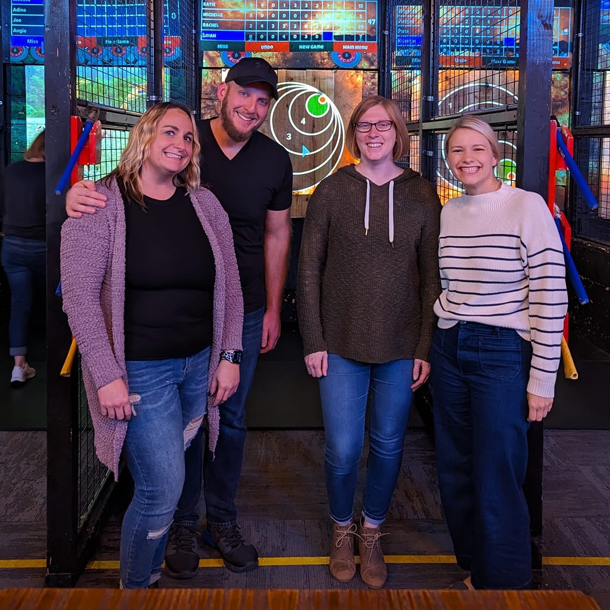 A group of Emerging Leaders at an axe throwing facility.