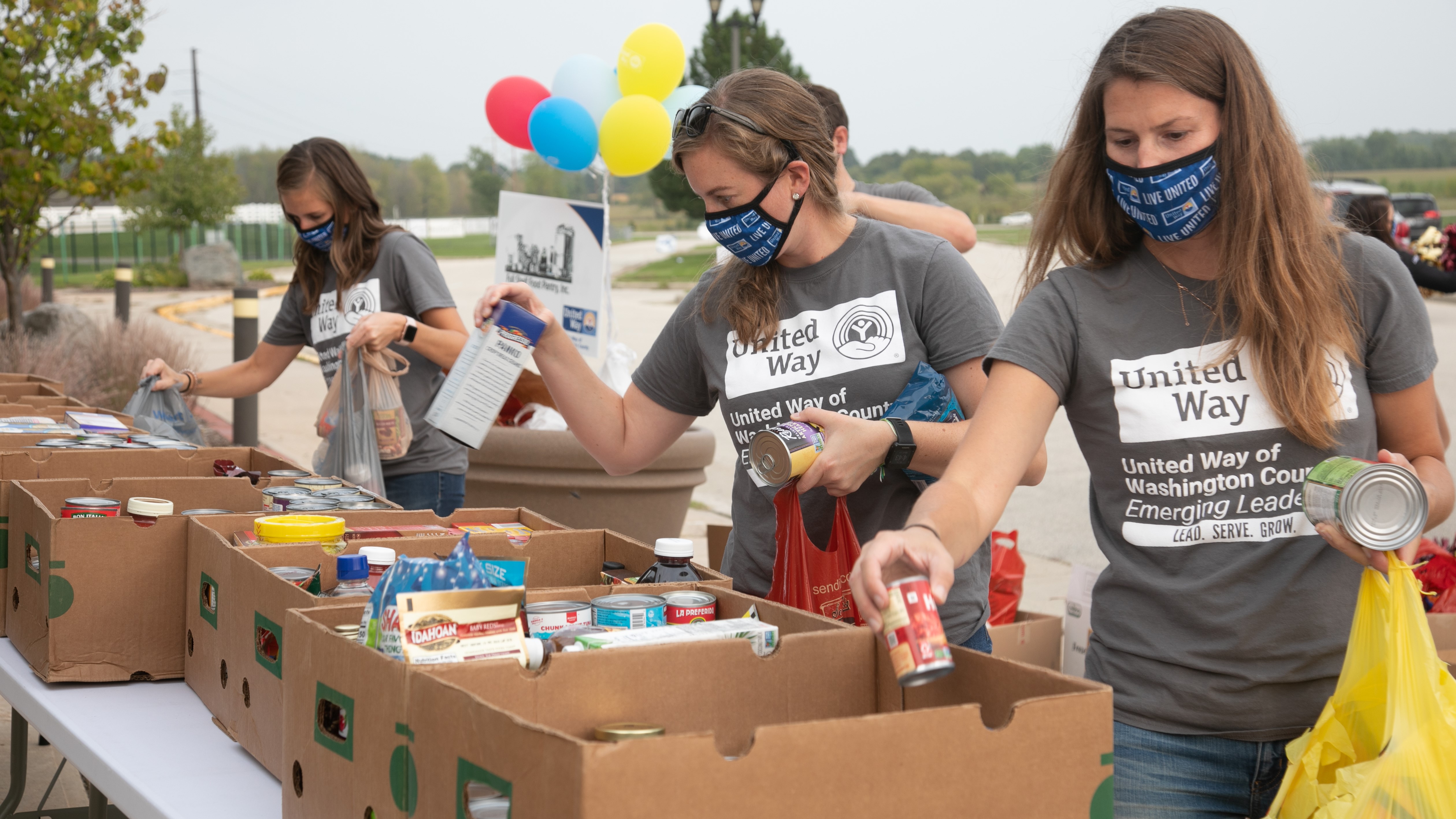 United Way Emerging Leaders packing food at the United Against Hunger event.