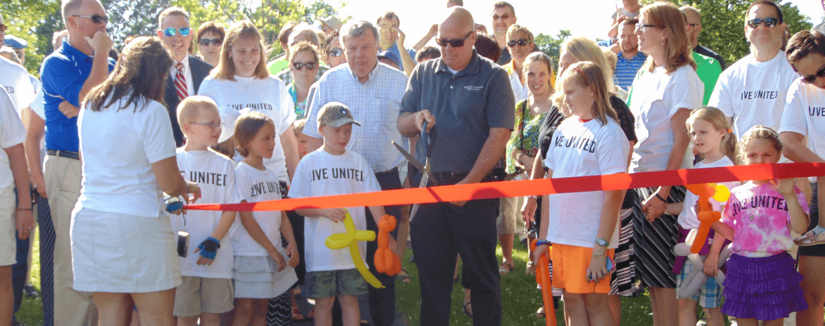 Children and community leaders at a ribbon cutting for the Villa Park Born Learning Trail in 2016.