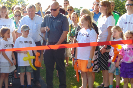 Children and community leaders at a ribbon cutting for the Villa Park Born Learning Trail in 2016.