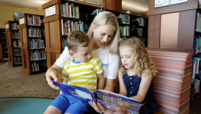 Image of a mother reading two her two children.